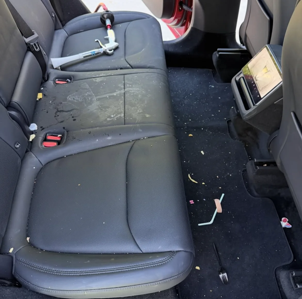 Rear seats before detailing, crumbs and stains visible